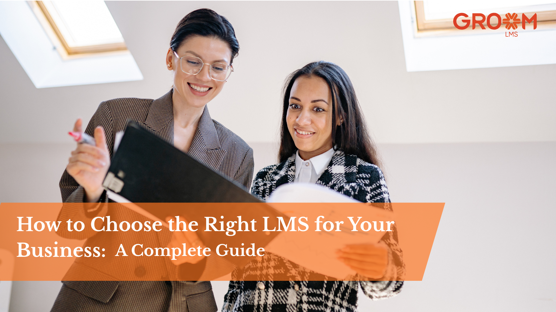 Two business professionals reviewing documents while evaluating learning management system options for employee training and development.