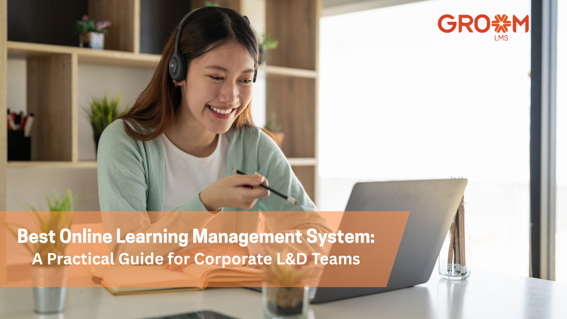A professional woman wearing a headset participates in an online learning session on her laptop. The image features the GroomLMS logo and the title "Best Online Learning Management System: A Practical Guide for Corporate L&D Teams."