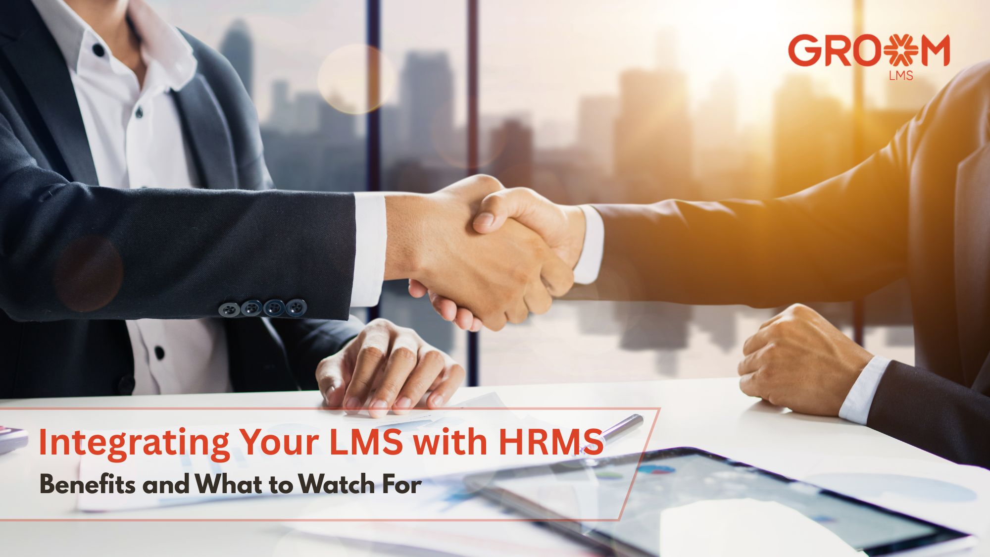 Professionals shaking hands to represent LMS and HRMS integration with GroomLMS