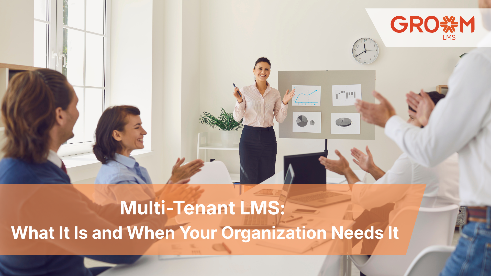 Business team attending a corporate training session demonstrating how a multi-tenant LMS helps organizations manage and scale learning across multiple teams.