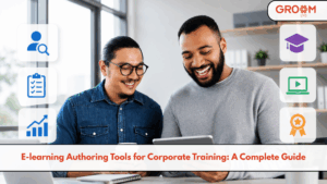Two professionals using a tablet with e-learning authoring tools and GroomLMS for corporate training.