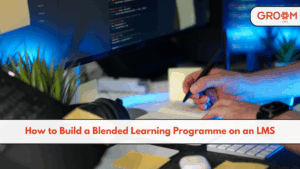 Laptop displaying a blended learning programme on an LMS with online modules, live sessions, classroom training, assessments, and learner progress tracking.