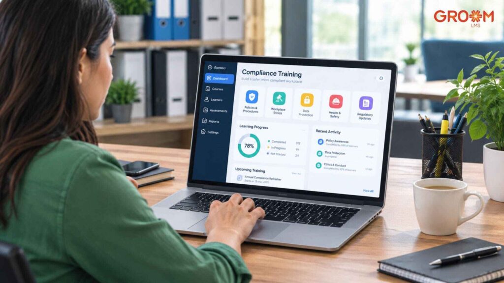 Woman using a compliance training dashboard on a laptop