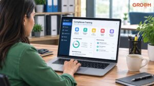 Woman using a compliance training dashboard on a laptop